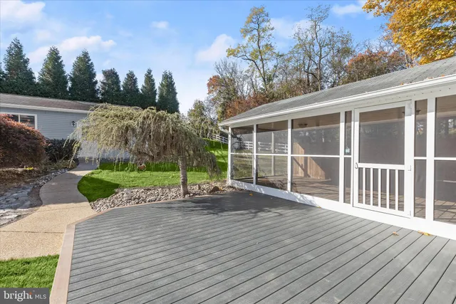 a view of a house with backyard and a tree