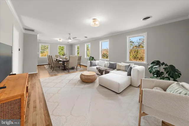 a spacious bedroom with a bed and a chandelier