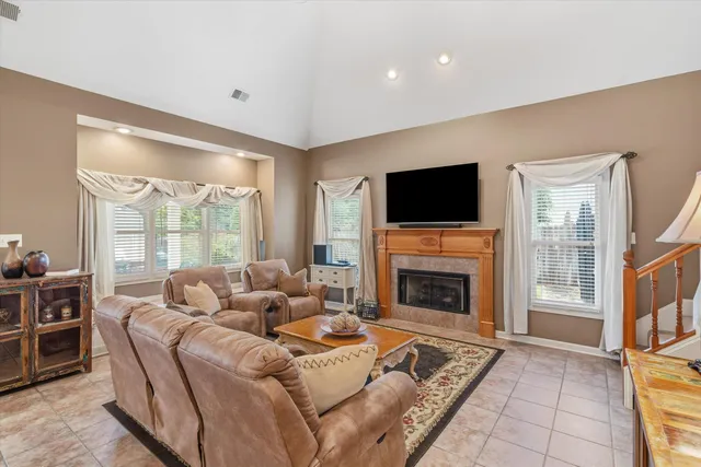 a living room with furniture flat screen tv and a fireplace