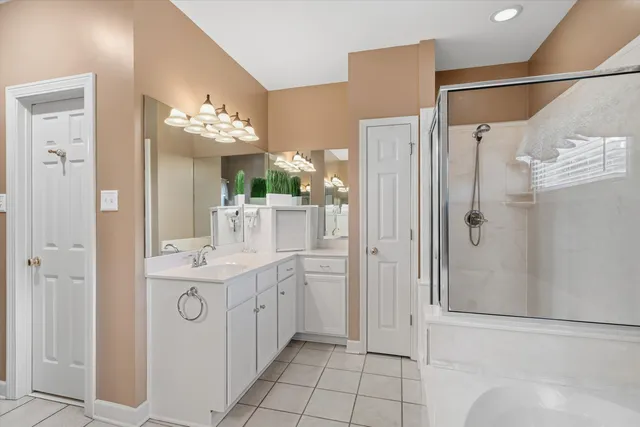a bathroom with a double vanity sink mirror and shower