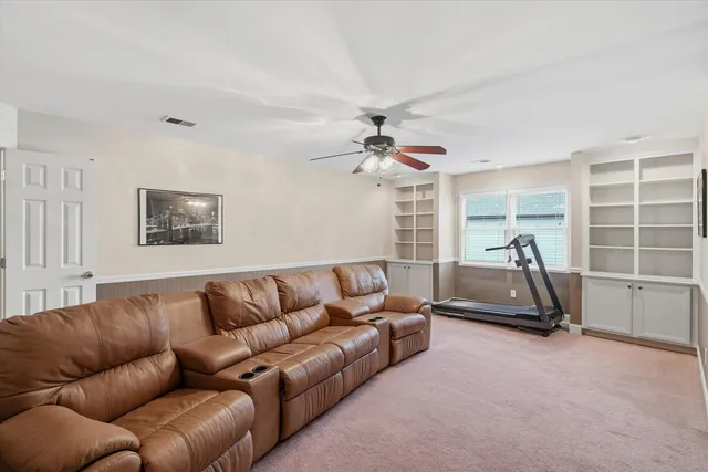 a living room with furniture gym equipment and a window