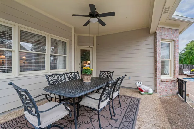a view of a dinning table and chairs in the patio