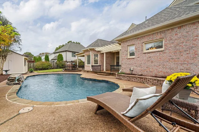 a view of a house with swimming pool and sitting area