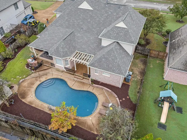 an aerial view of a house with a swimming pool