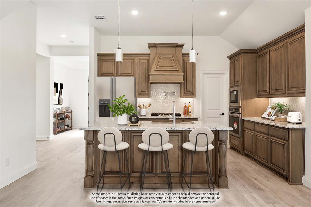 2016 Hickory Chase Lane Anna, TX 75409 - Photo 14 of 35 a kitchen with stainless steel appliances kitchen island granite countertop a table chairs sink and cabinets