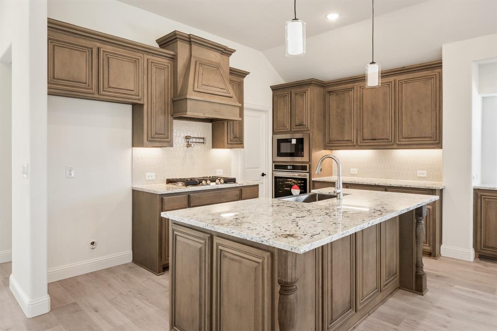2016 Hickory Chase Lane Anna, TX 75409 - Photo 15 of 35 a kitchen with stainless steel appliances granite countertop a kitchen island a cabinets and wooden floor