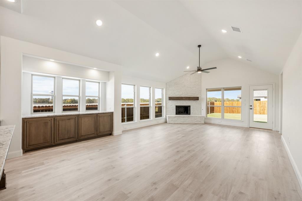 2016 Hickory Chase Lane Anna, TX 75409 - Photo 16 of 35 an empty room with wooden floor and fireplace