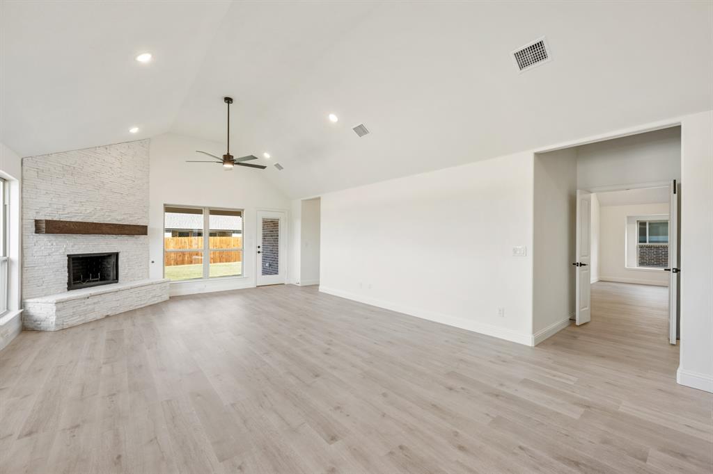 2016 Hickory Chase Lane Anna, TX 75409 - Photo 20 of 35 an empty room with wooden floor fireplace and windows