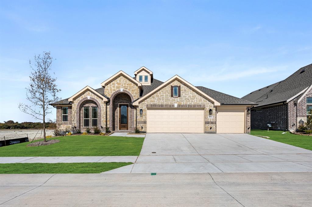 2016 Hickory Chase Lane Anna, TX 75409 - Photo 2 of 35 a front view of a house with a yard and garage