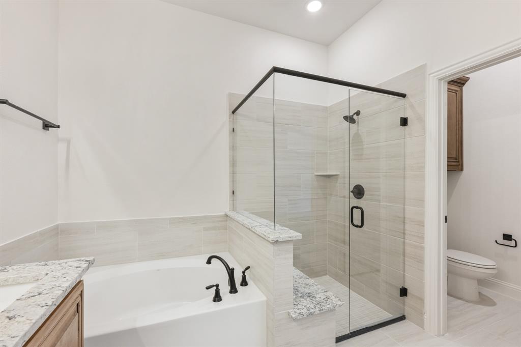 2016 Hickory Chase Lane Anna, TX 75409 - Photo 25 of 35 a bathroom with a granite countertop bathtub shower sink vanity and toilet