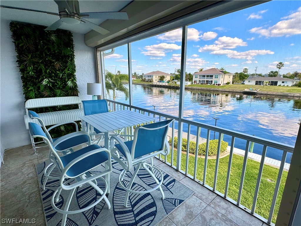 a view of a balcony with lake view and a floor to ceiling window