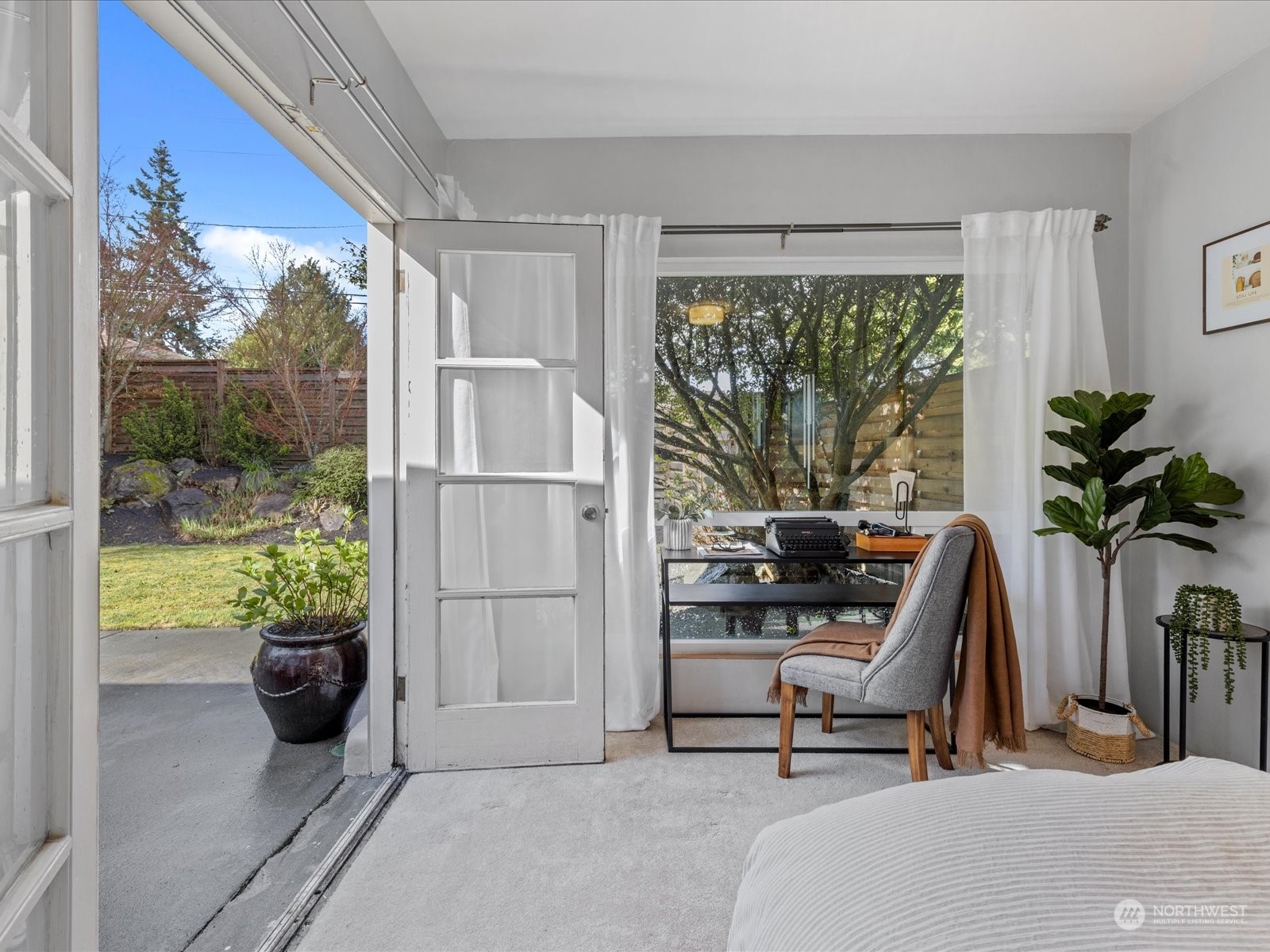 3735 Southwest 106th Street Seattle, WA 98146 - Photo 13 of 30 a view of a room with a floor to ceiling window and potted plants