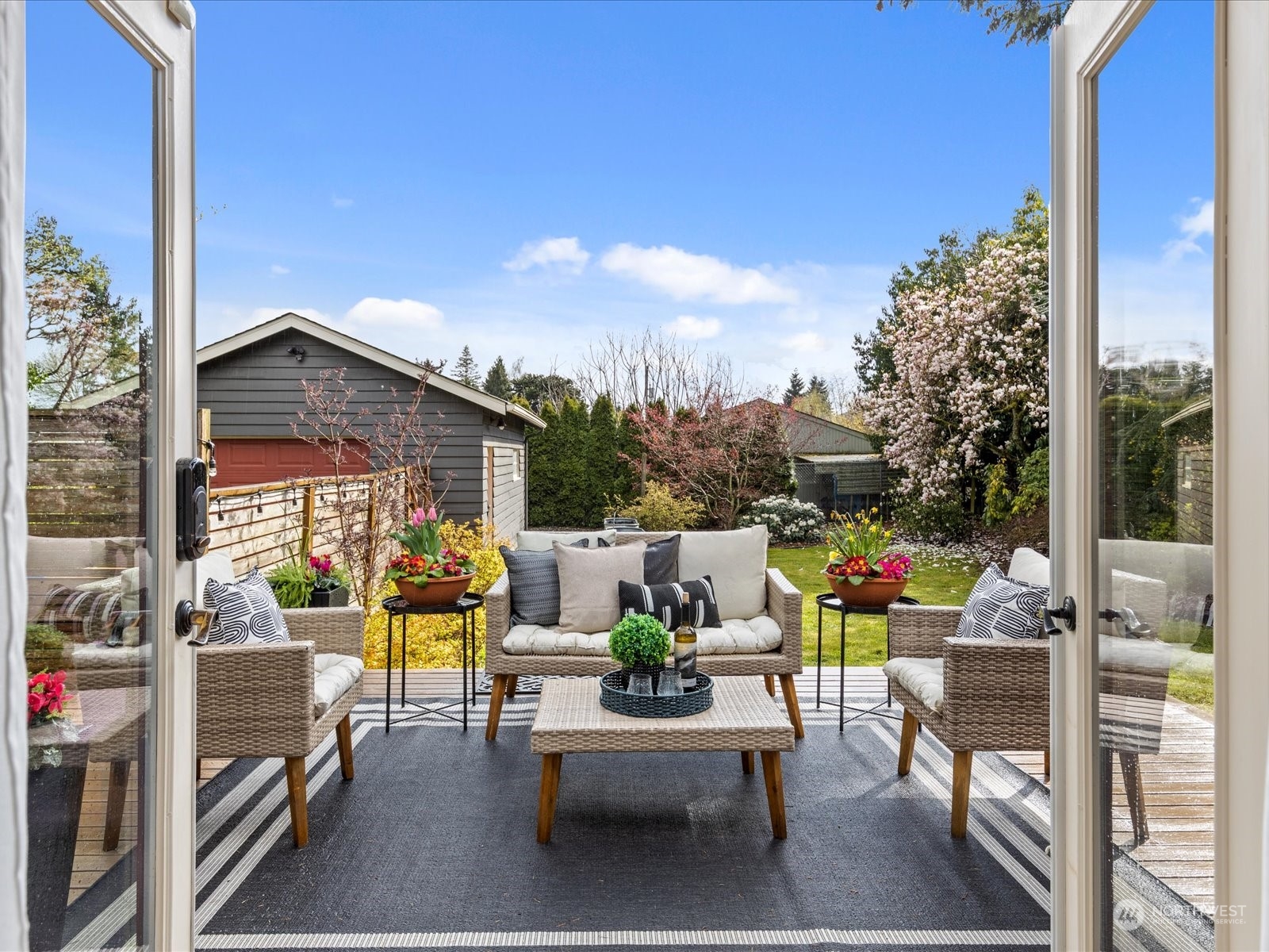 3735 Southwest 106th Street Seattle, WA 98146 - Photo 10 of 30 a view of a patio with couches chairs potted plants and a palm tree