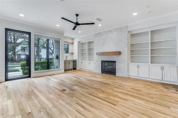 a view of an empty room with a fireplace and a window