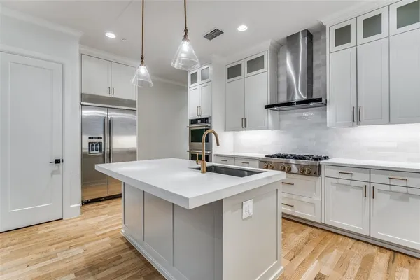 a kitchen with stainless steel appliances granite countertop a sink stove and refrigerator