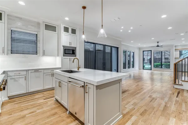 a kitchen with a stove a sink and a refrigerator