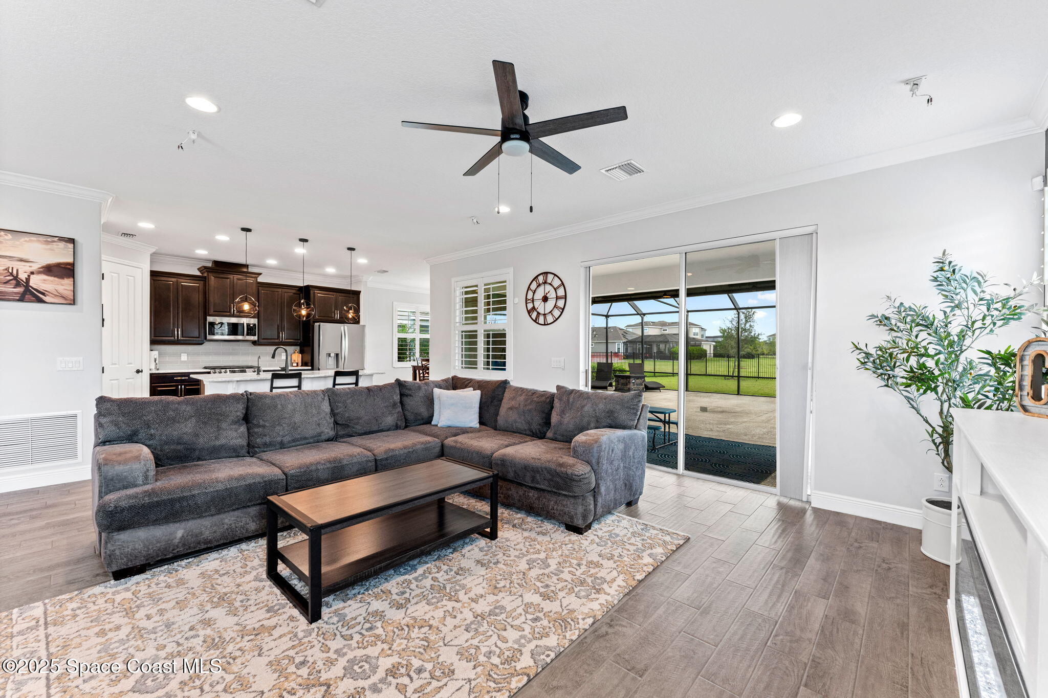 8215 Millbrook Avenue Melbourne, FL 32940 - Photo 14 of 62 a living room with furniture and a large window