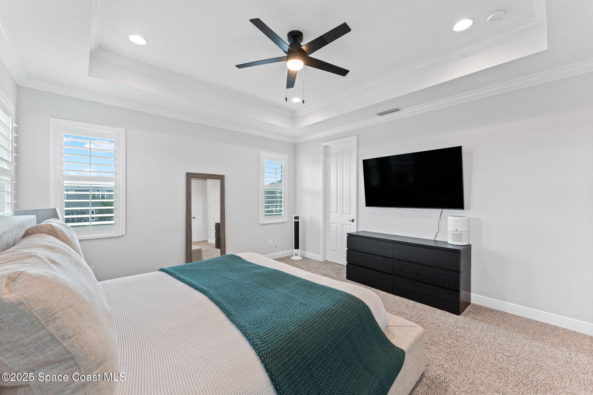 8215 Millbrook Avenue Melbourne, FL 32940 - Photo 26 of 62 a bedroom with a bed tv and a window