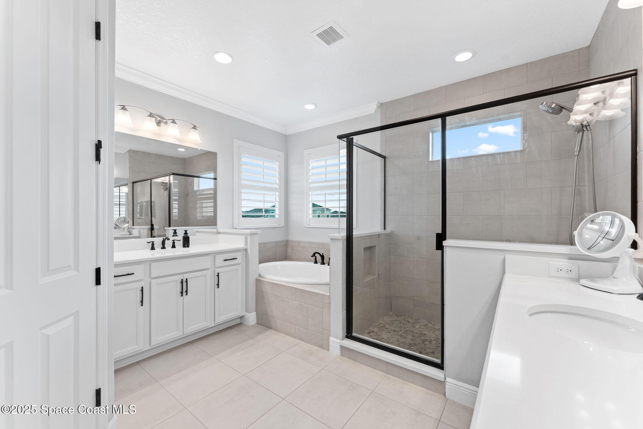 8215 Millbrook Avenue Melbourne, FL 32940 - Photo 27 of 62 a bathroom with a granite countertop sink mirror and shower