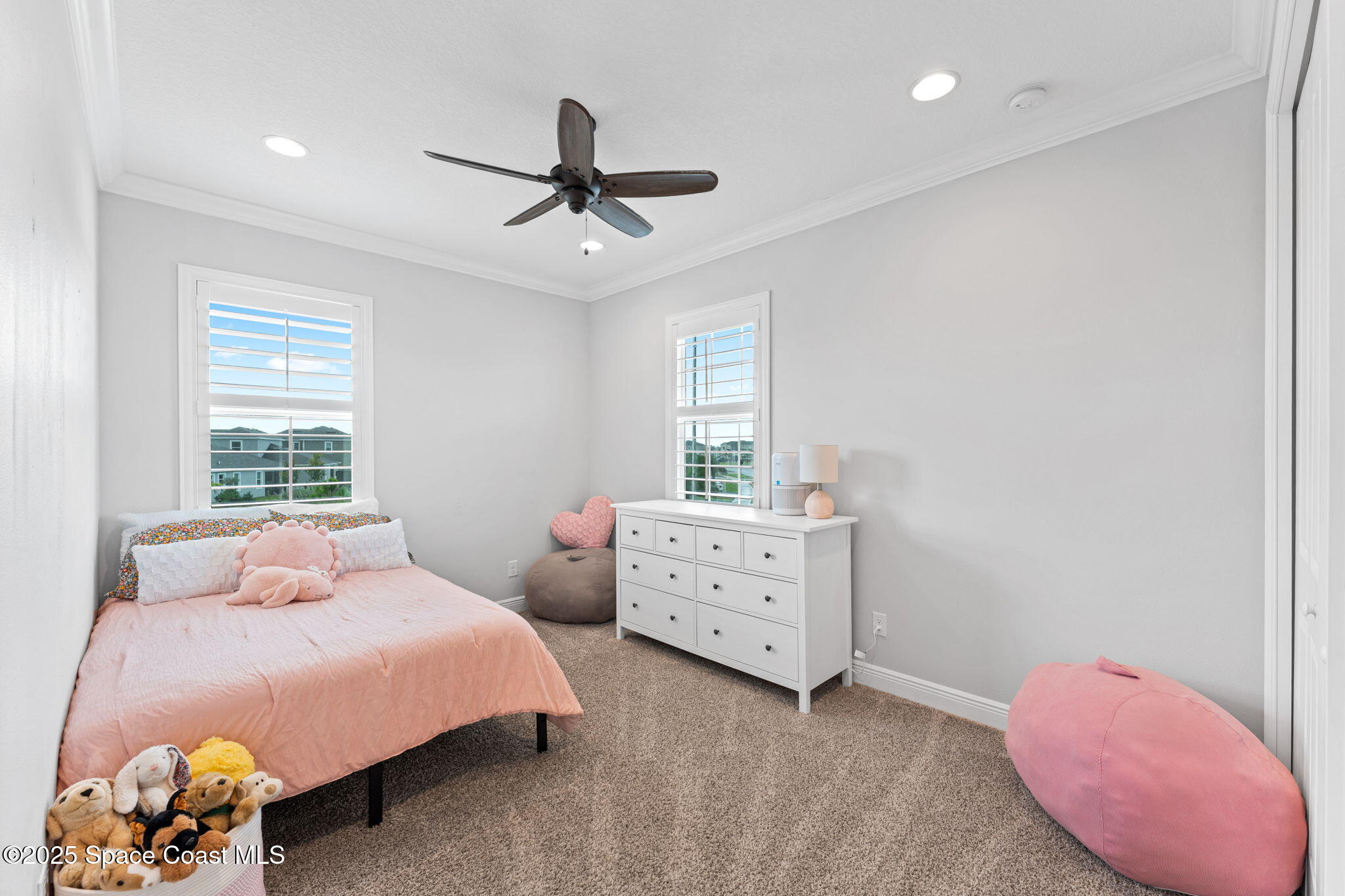 8215 Millbrook Avenue Melbourne, FL 32940 - Photo 30 of 62 a bedroom with a bed and a dresser