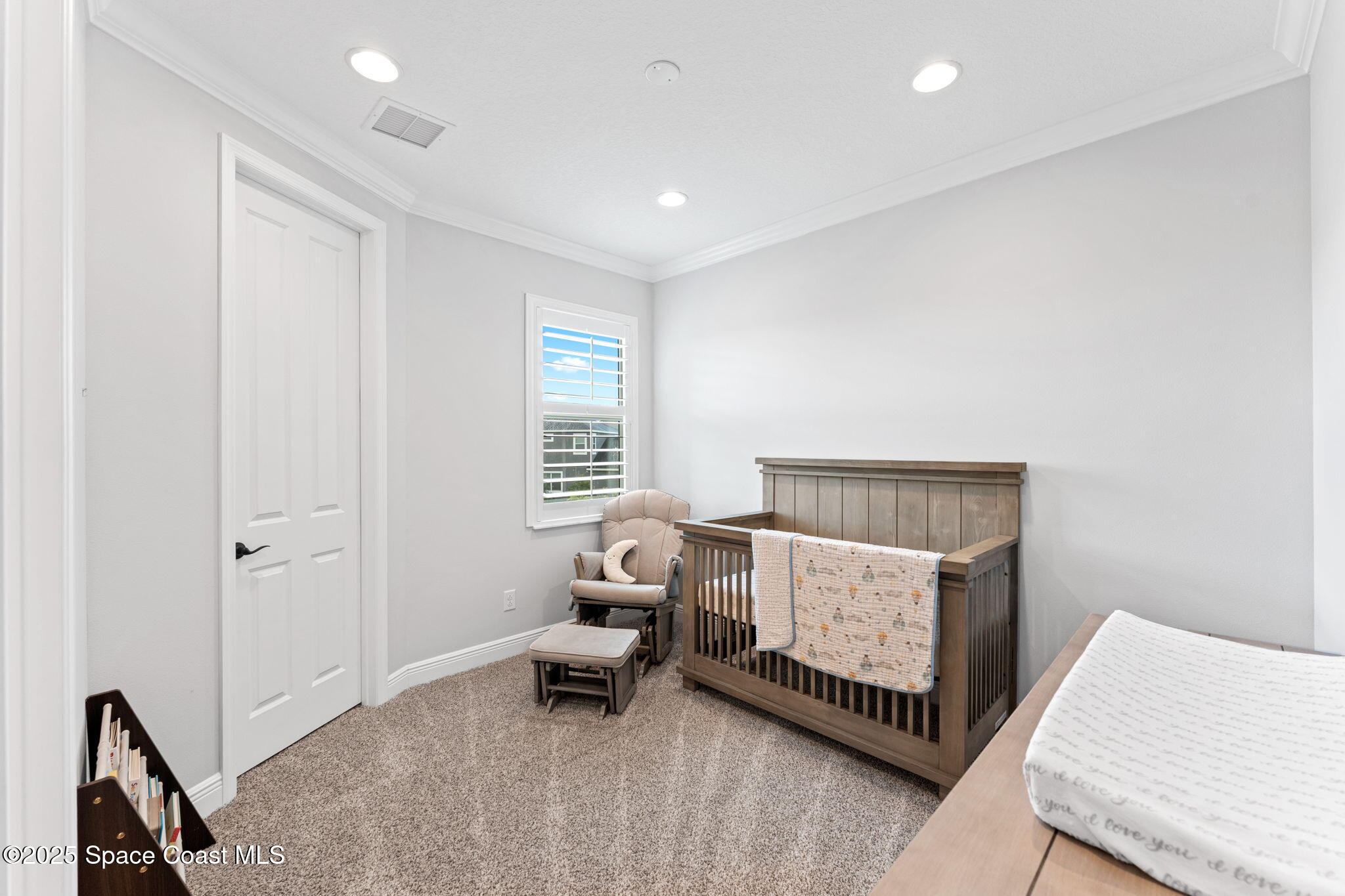 8215 Millbrook Avenue Melbourne, FL 32940 - Photo 33 of 62 a living room with furniture and a window
