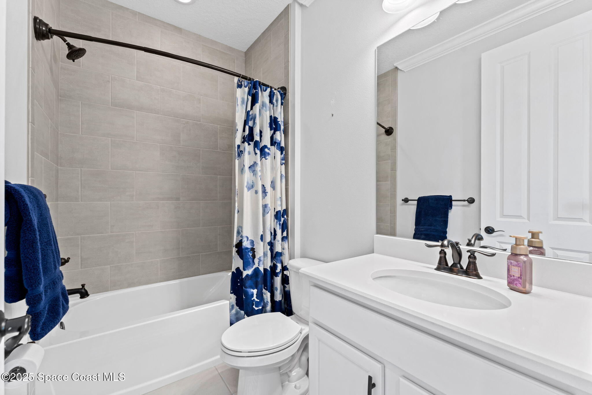 8215 Millbrook Avenue Melbourne, FL 32940 - Photo 34 of 62 a bathroom with a sink a toilet and a bathtub