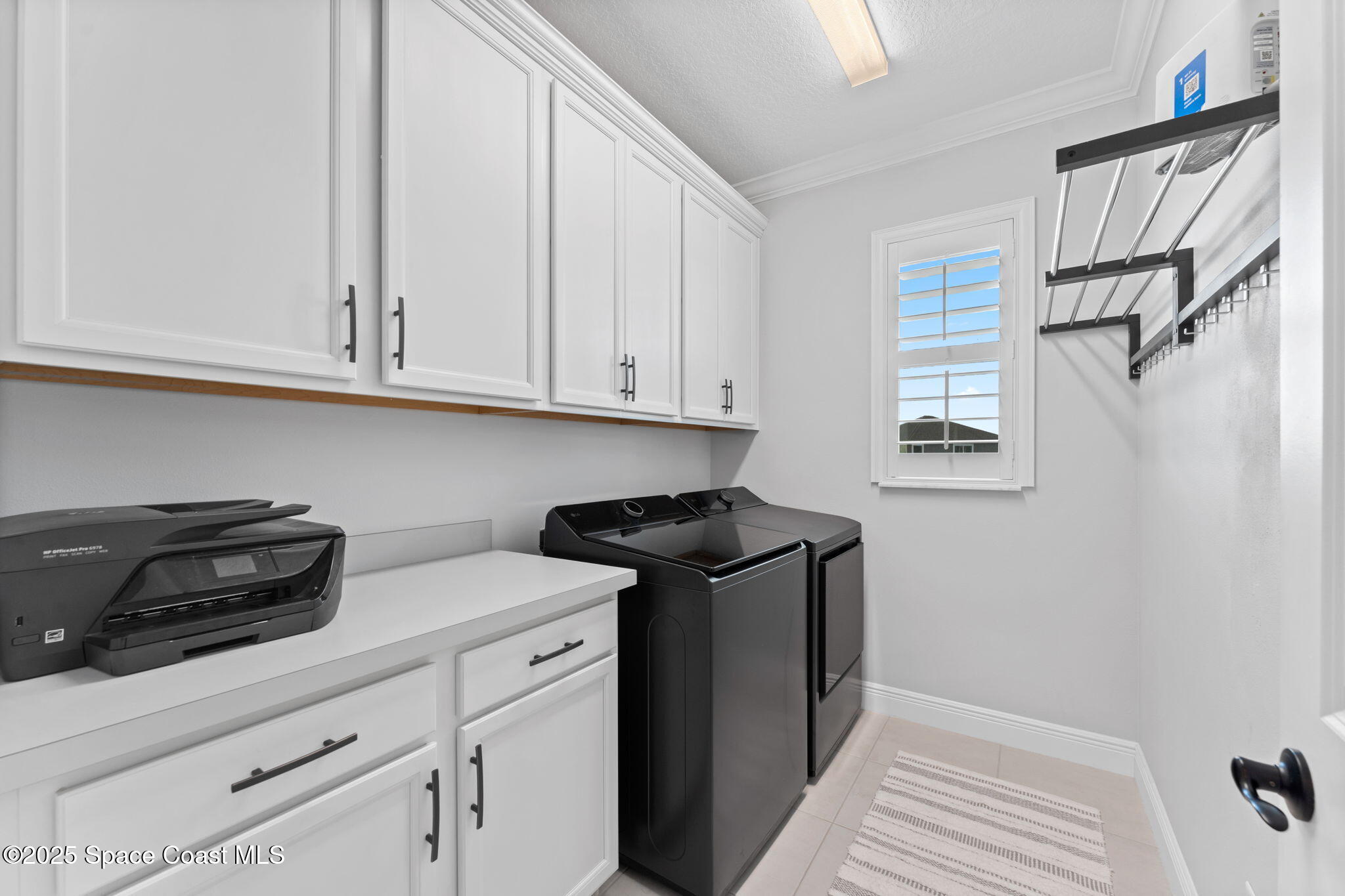 8215 Millbrook Avenue Melbourne, FL 32940 - Photo 36 of 62 a kitchen with stainless steel appliances granite countertop white cabinets and a stove