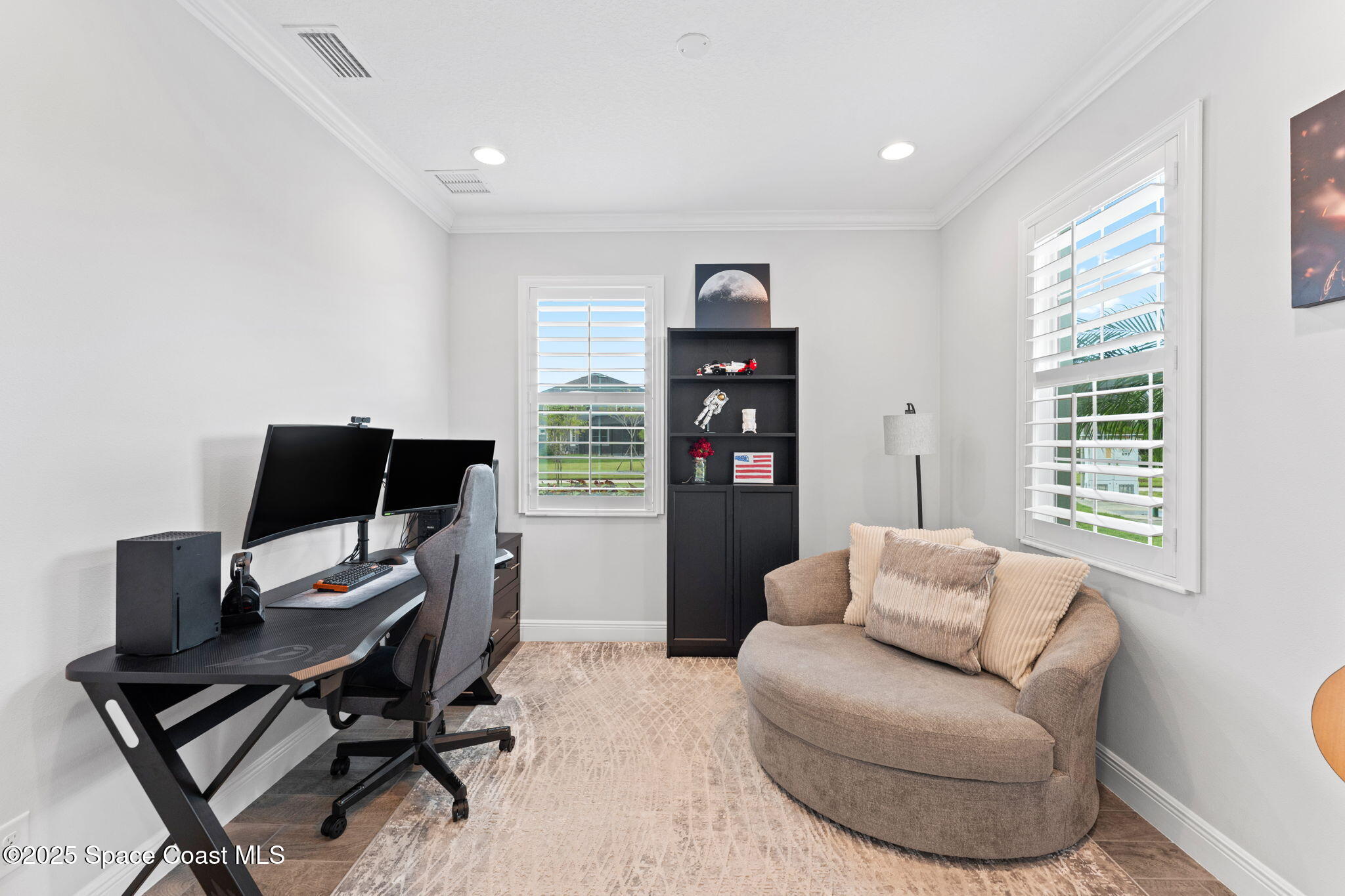 8215 Millbrook Avenue Melbourne, FL 32940 - Photo 5 of 62 a workspace with furniture and a window