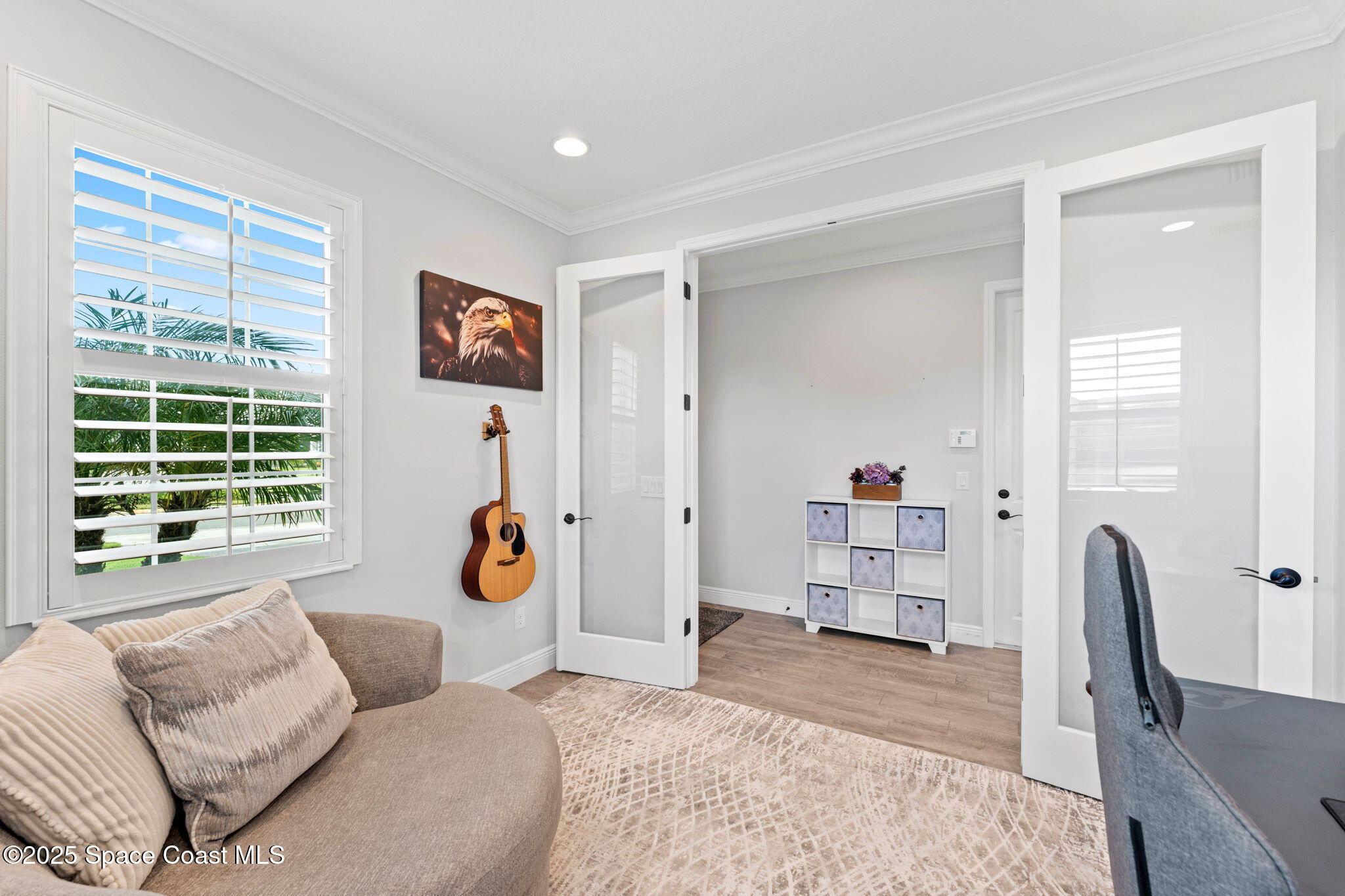 8215 Millbrook Avenue Melbourne, FL 32940 - Photo 6 of 62 a bedroom with furniture and a window