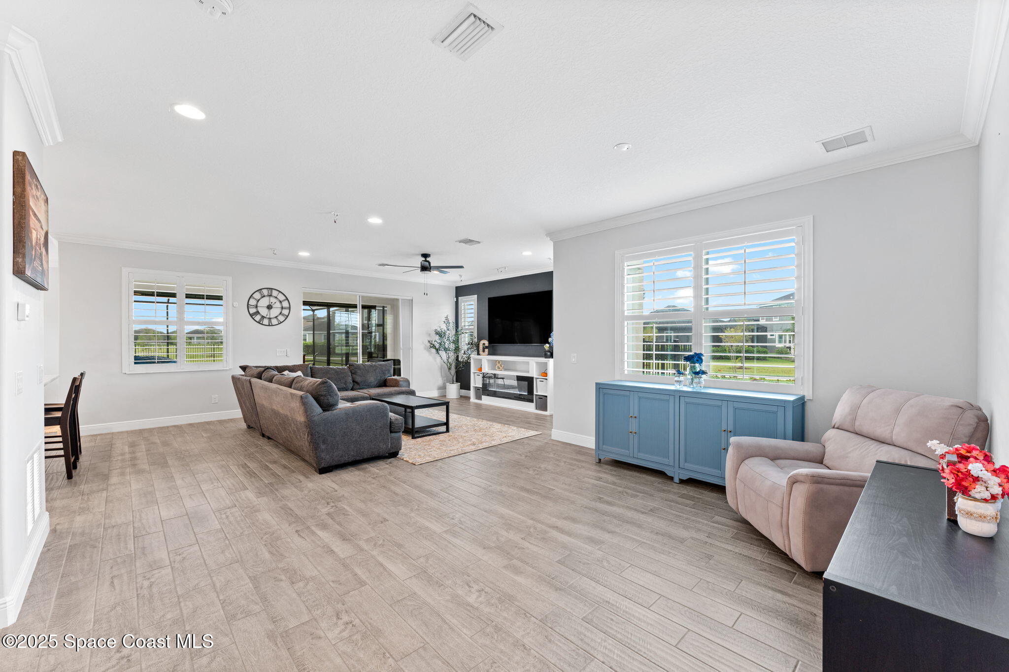 8215 Millbrook Avenue Melbourne, FL 32940 - Photo 7 of 62 a living room with furniture and a flat screen tv