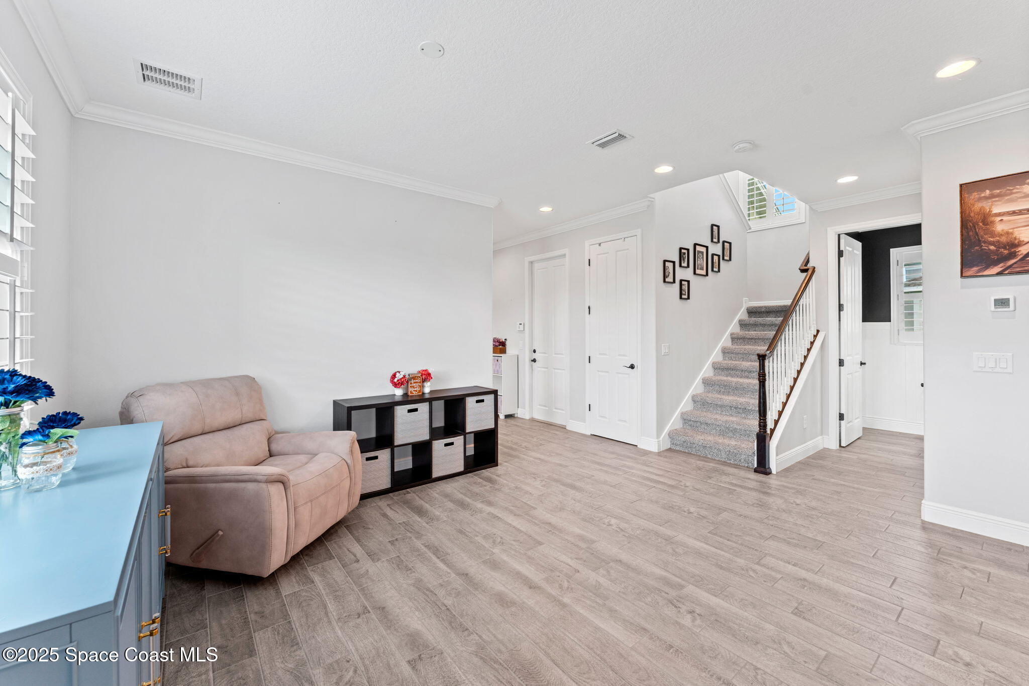 8215 Millbrook Avenue Melbourne, FL 32940 - Photo 9 of 62 a living room with furniture and wooden floor