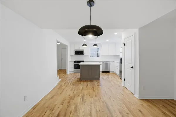 a spacious bedroom with a bed and a table