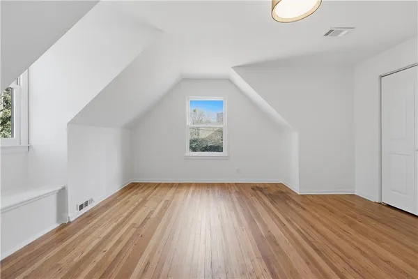 a view of a livingroom with a fireplace wooden floor and window