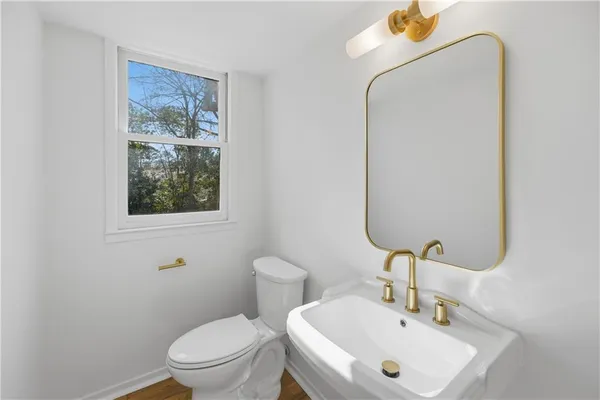 a view of a house with a yard and potted plants