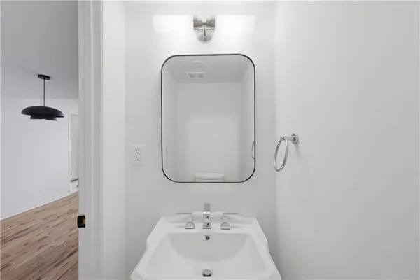 a view of a hallway with wooden floor and entryway