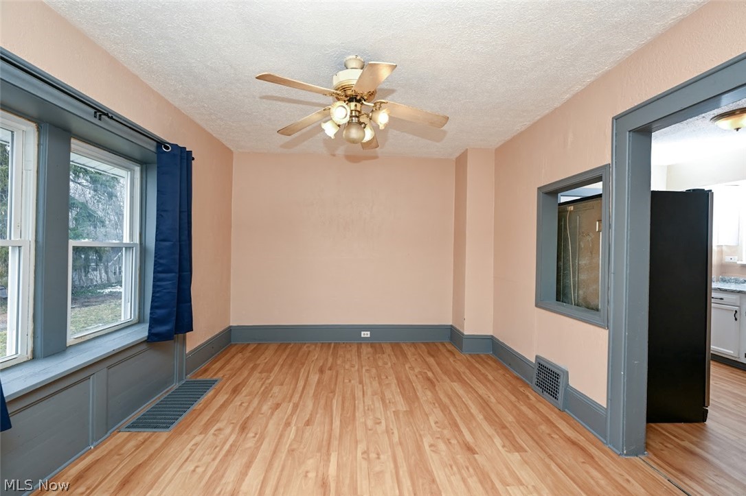 77 West Mildred Avenue Akron, OH 44310 - Photo 10 of 40 Spare room with a ceiling fan, light wood-type flooring, and a textured ceiling
