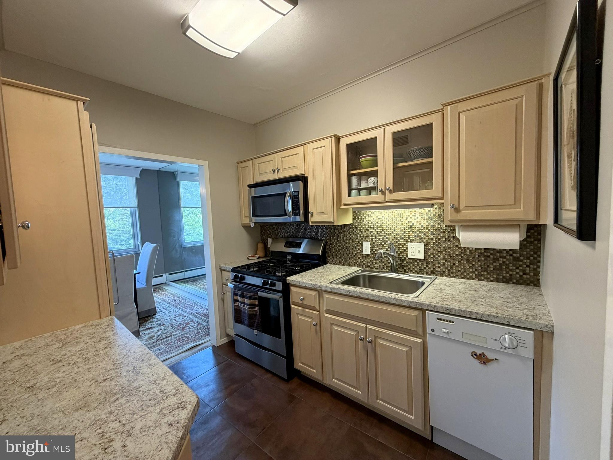 191 Presidential Boulevard, Unit R403 Bala Cynwyd, PA 19004 - Photo 15 of 30 a kitchen with stainless steel appliances granite countertop a stove a sink and a microwave