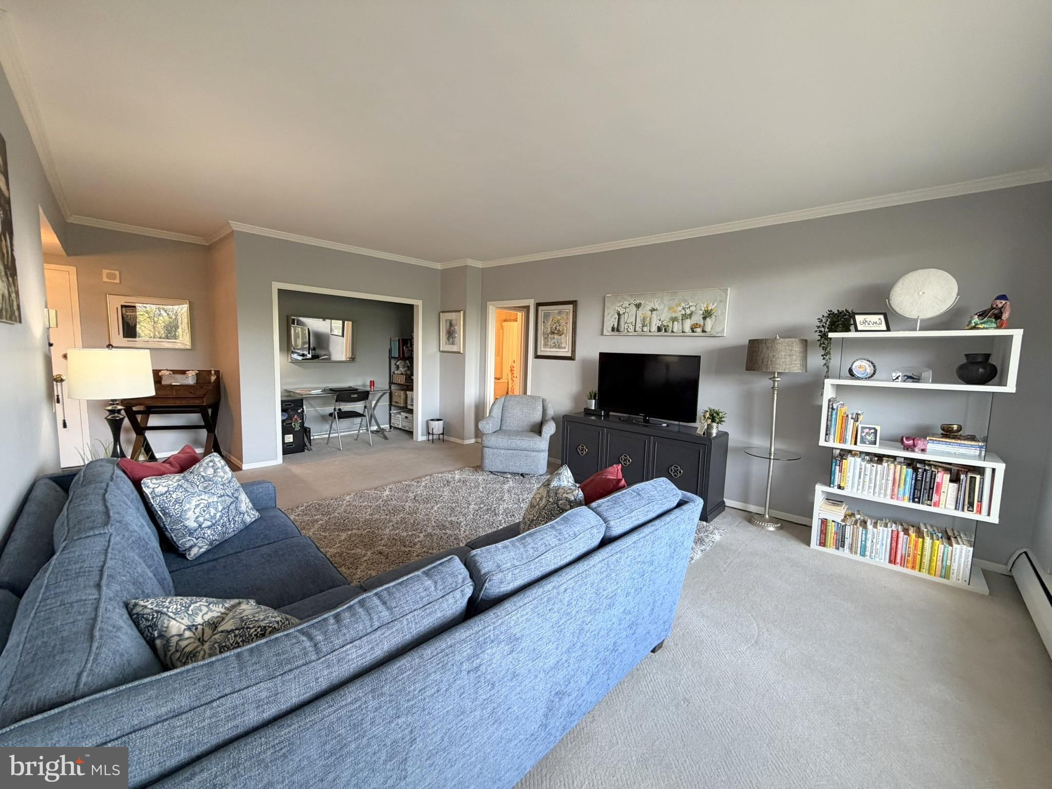 191 Presidential Boulevard, Unit R403 Bala Cynwyd, PA 19004 - Photo 21 of 30 a living room with furniture and a flat screen tv