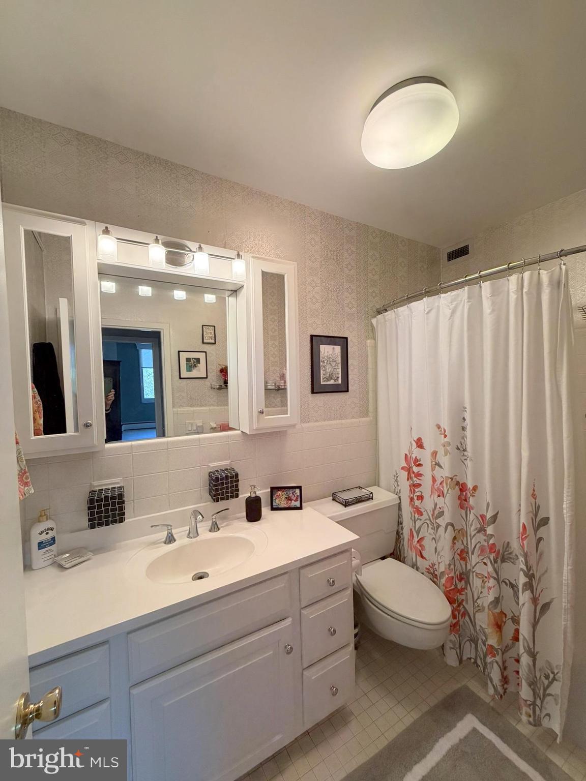 191 Presidential Boulevard, Unit R403 Bala Cynwyd, PA 19004 - Photo 25 of 30 a bathroom with a double vanity sink and a mirror