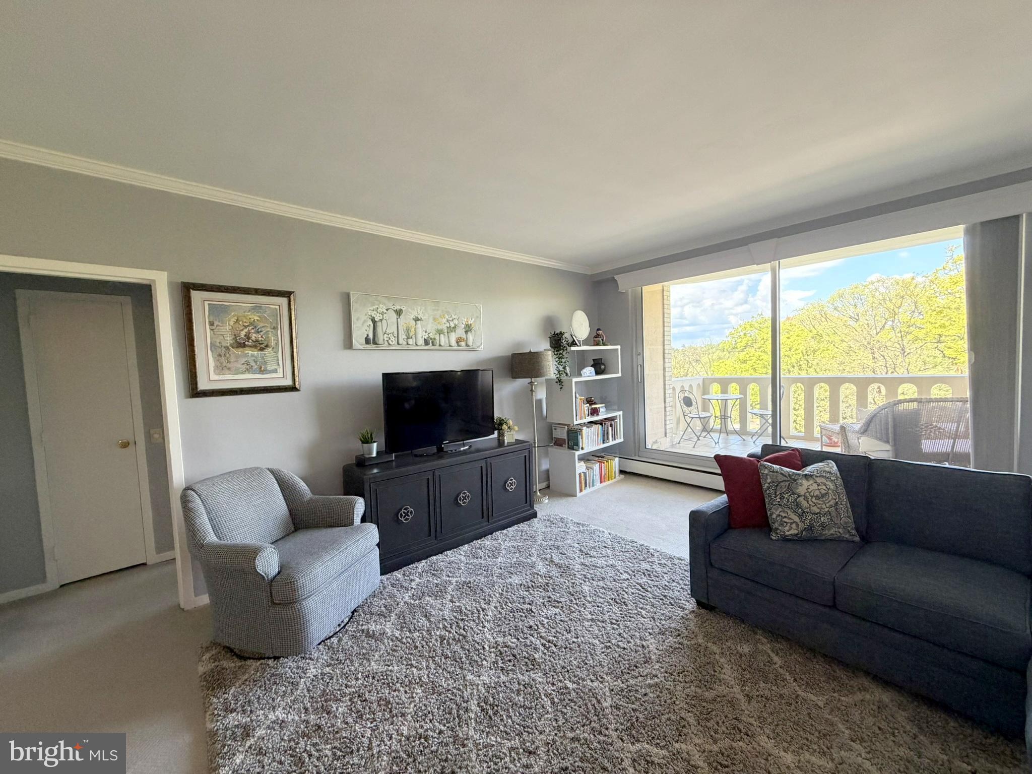 191 Presidential Boulevard, Unit R403 Bala Cynwyd, PA 19004 - Photo 8 of 30 a living room with furniture and a flat screen tv
