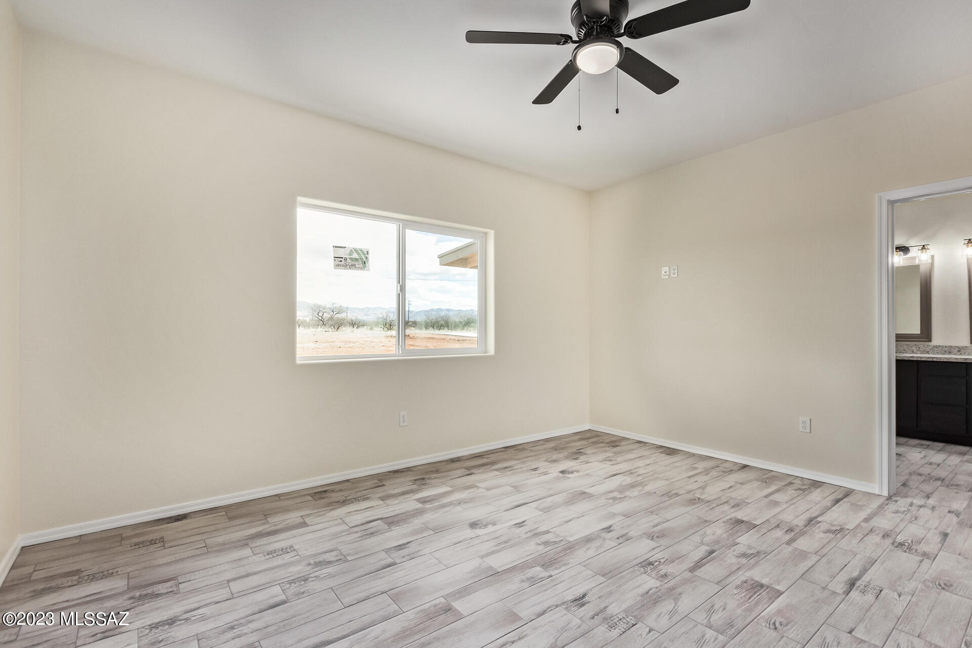 1795 Escobedo Court Rio Rico, AZ 85648 - Photo 16 of 30 a view of empty room with wooden floor and ceiling fan