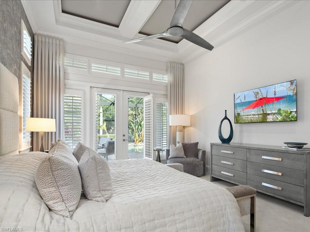 4249 Deephaven Lane Naples, FL 34119 - Photo 11 of 50 a bedroom with a bed and a flat screen tv