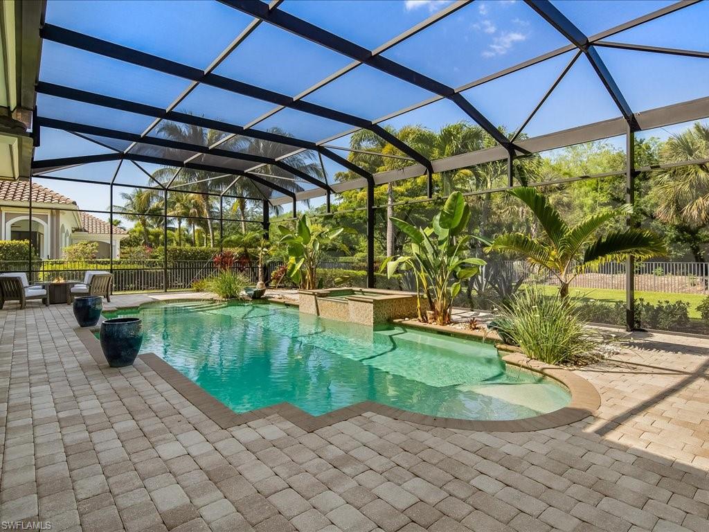 4249 Deephaven Lane Naples, FL 34119 - Photo 16 of 50 a view of a swimming pool with a patio