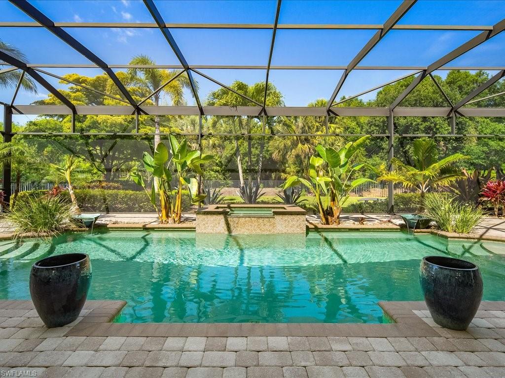 4249 Deephaven Lane Naples, FL 34119 - Photo 17 of 50 a view of a swimming pool with a patio