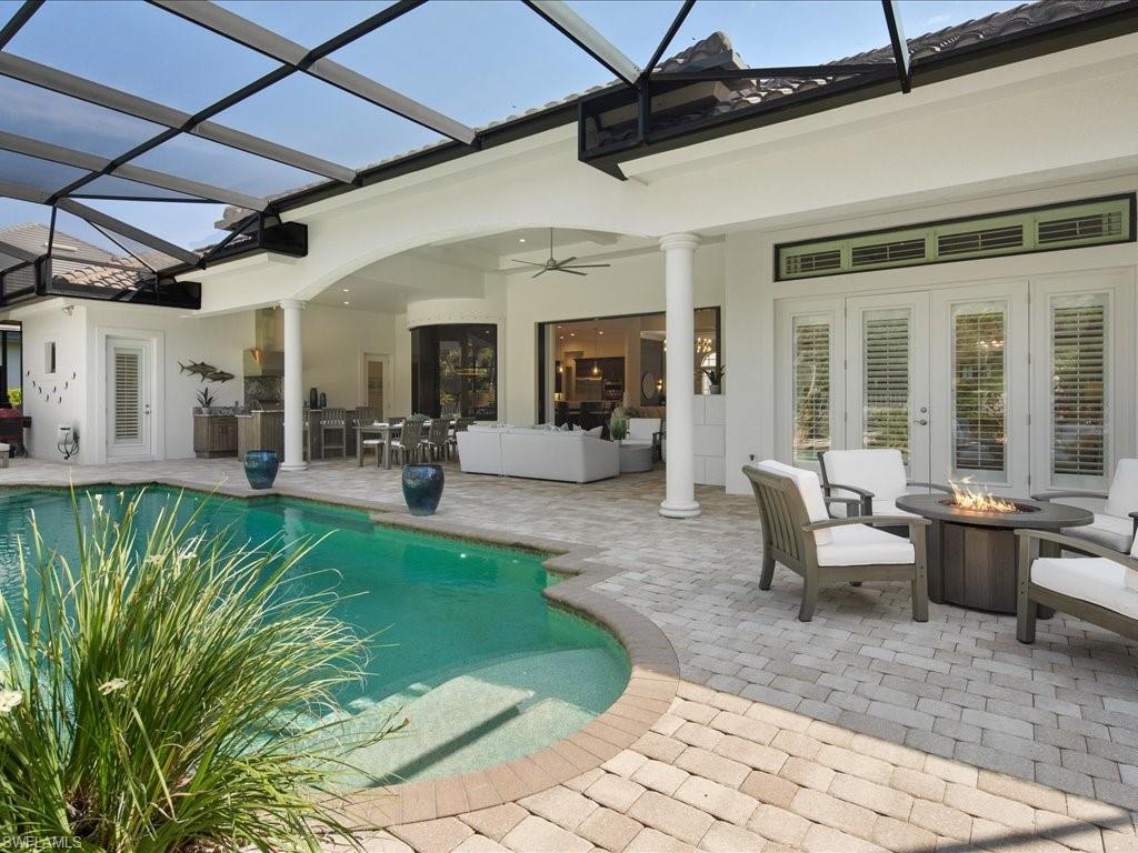 4249 Deephaven Lane Naples, FL 34119 - Photo 21 of 50 a view of a patio with table and chairs with wooden floor and plants
