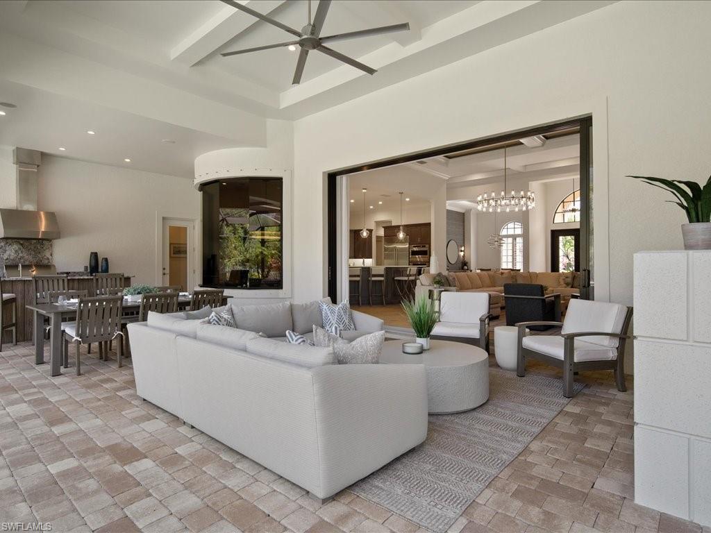 4249 Deephaven Lane Naples, FL 34119 - Photo 22 of 50 a living room with furniture and a large window