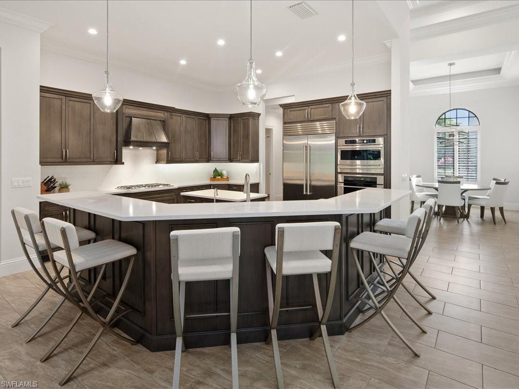 4249 Deephaven Lane Naples, FL 34119 - Photo 23 of 50 a kitchen with a table and chairs in it