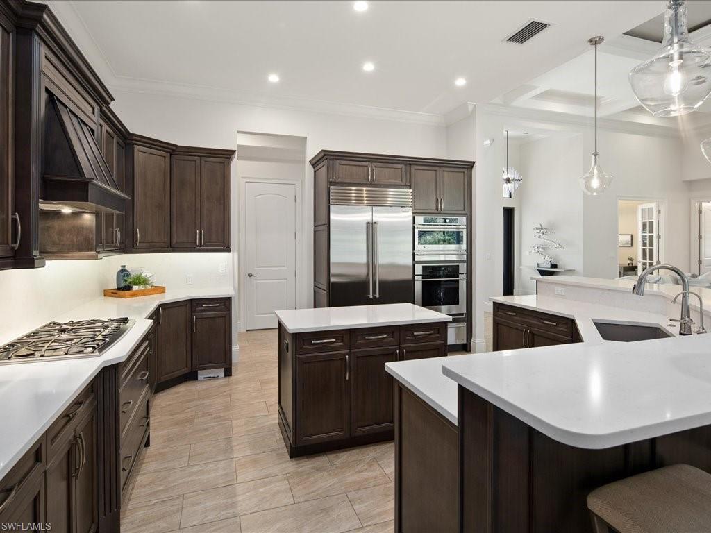 4249 Deephaven Lane Naples, FL 34119 - Photo 24 of 50 a kitchen with granite countertop a sink stove and cabinets