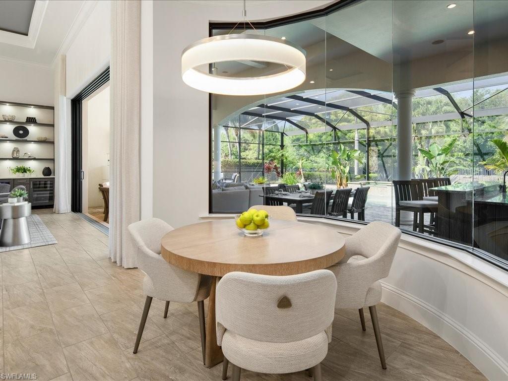 4249 Deephaven Lane Naples, FL 34119 - Photo 28 of 50 a dining room with furniture a window and dining table