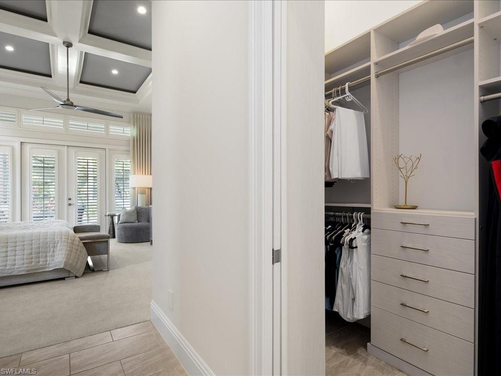 4249 Deephaven Lane Naples, FL 34119 - Photo 33 of 50 a view of walk in closet with clothes and shoes